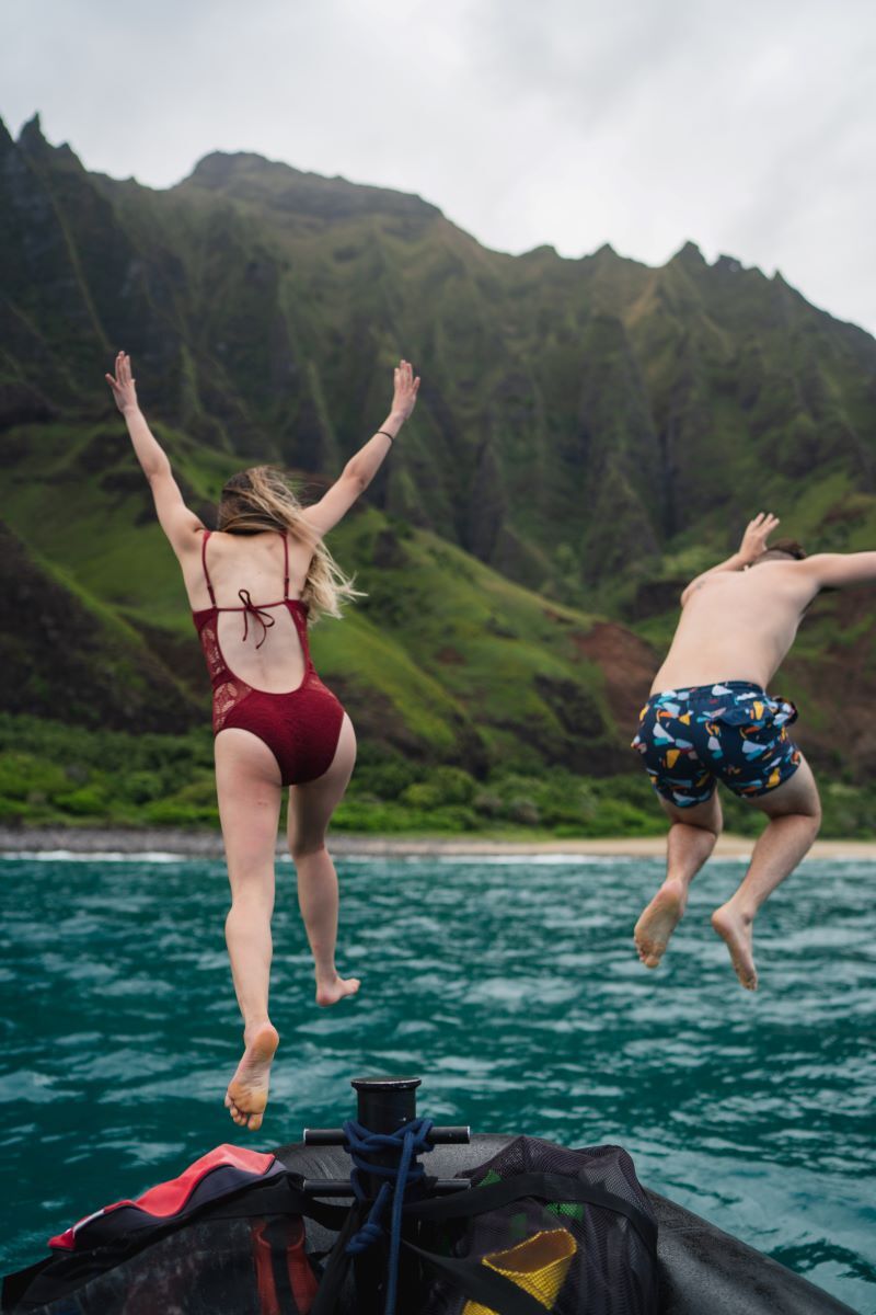 kids jumping into water on kauai