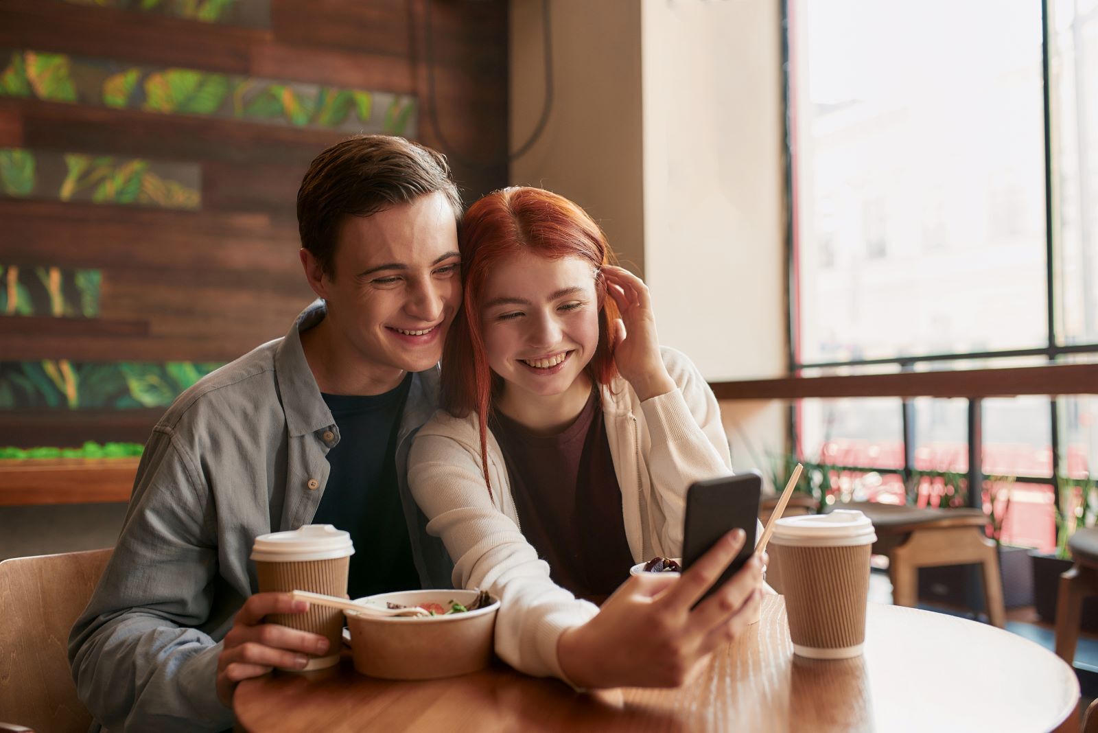 couple at kauai coffee shop enjoying lattes and taking a selfie