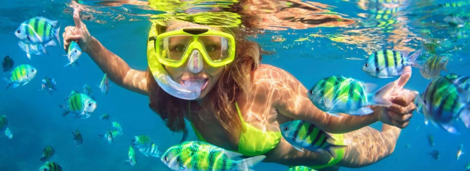 young girl snorkeling in tropical waters